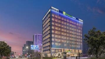 A modern hotel building with a prominent sign for Holiday Inn Express.