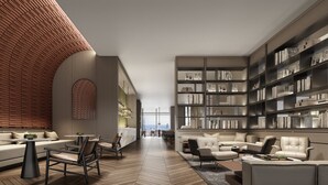 A modern interior with a brick wall, a large bookshelf, and a seating area with a sofa and chairs. - Crowne Plaza Jingmen by IHG (Jingmen)