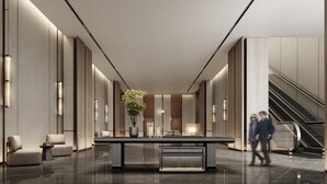 A modern lobby with a central table, seating, and an escalator. - Crowne Plaza Jingmen by IHG (Jingmen)