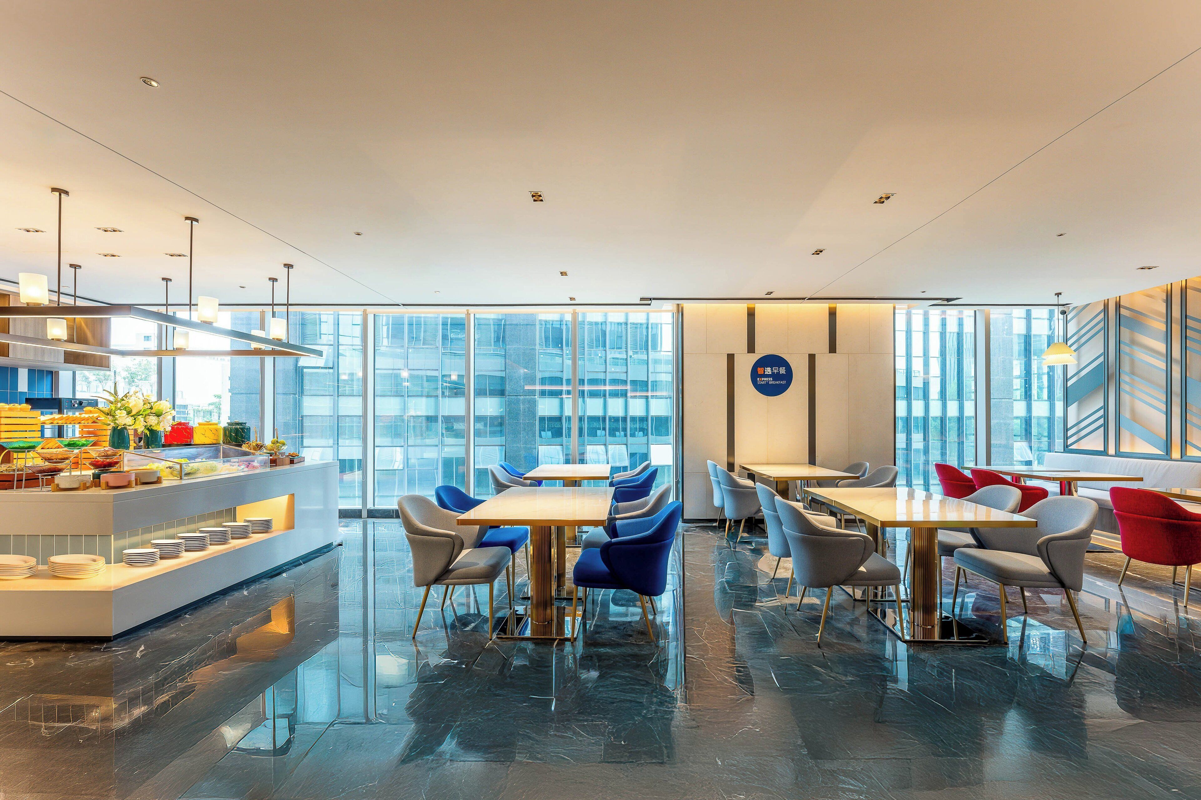 A modern dining area with glass walls, a buffet, and contemporary furniture.