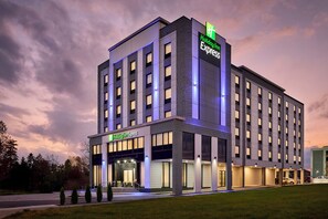 A Holiday Inn Express hotel with a modern facade, multiple entry points, and a parking area. - Holiday Inn Express Hamilton Upper James by IHG (Hamilton)