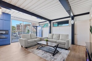 A modern living room with a sectional sofa, a coffee table, and a TV.