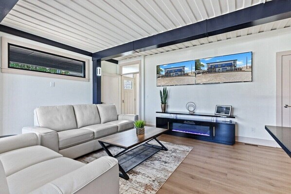 A modern living room with a sofa, coffee table, and entertainment unit.