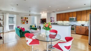 A modern kitchen with wooden cabinets, stainless steel appliances, and a central island.