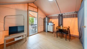 A compact, well-lit tent with a kitchenette, a dining area, and a TV. - Gapeyong Fourseason Pet Glamping Caravan (Gapyeong)