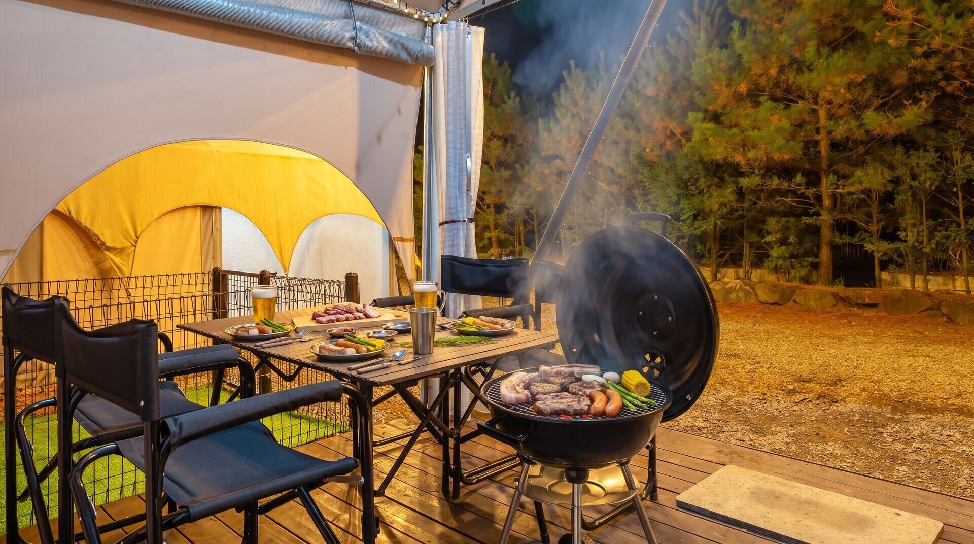An outdoor dining area with a grill, tent, and chairs.
