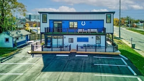 A two-story building with a blue and white color scheme, featuring a large horseshoe logo on the upper level.