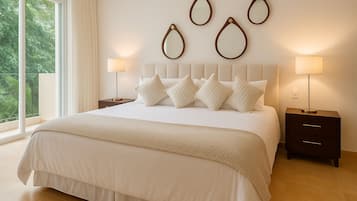 A modern bedroom with a large bed, multiple pillows, a bedside table with a lamp, and wall-mounted mirrors.