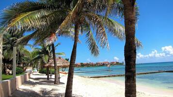 Privat strand, vit sandstrand, solstolar och parasoller