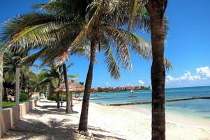Private beach, white sand, sun loungers, beach umbrellas