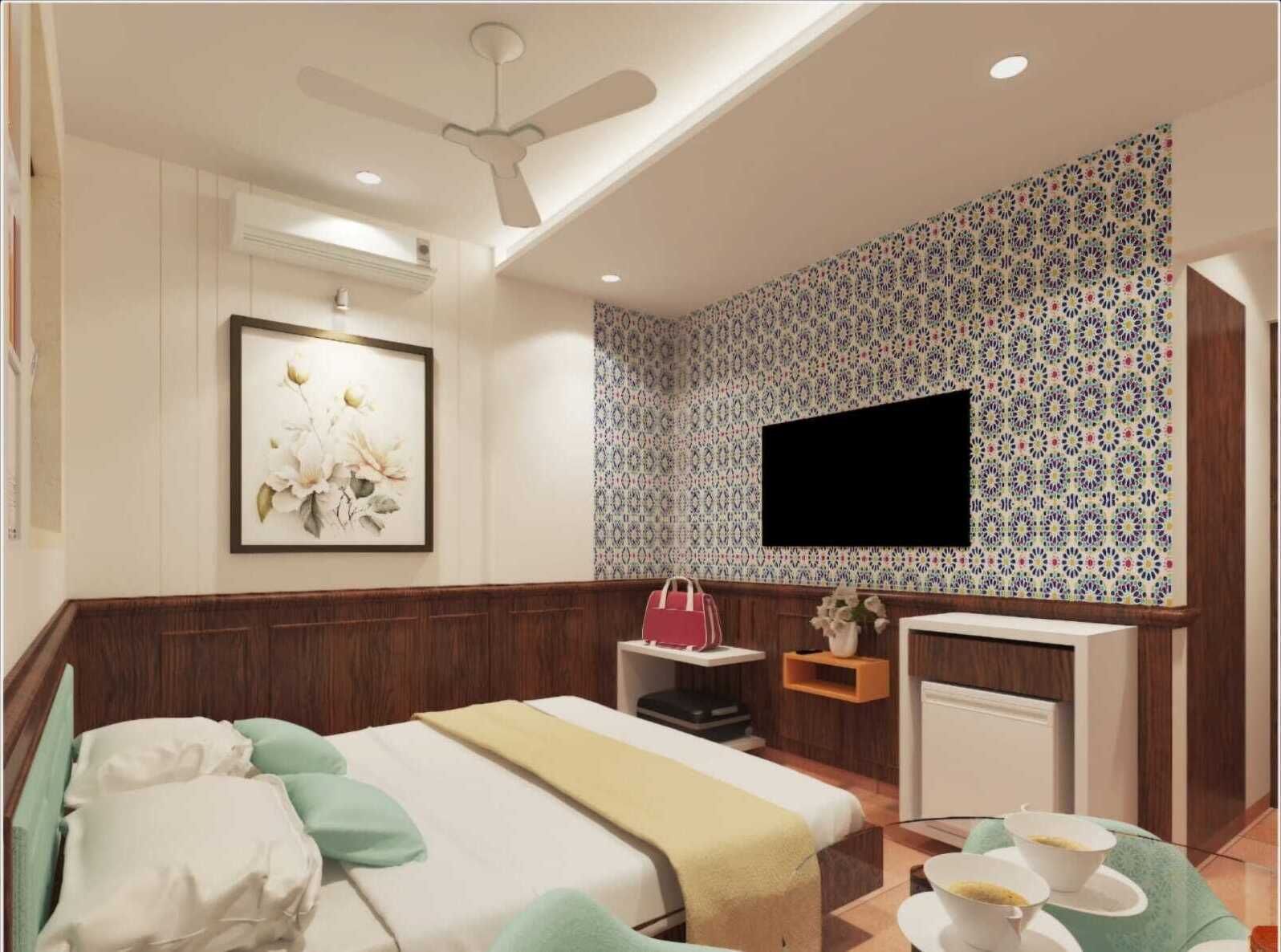 A hotel room with a bed, a desk, a TV, and a patterned wall.