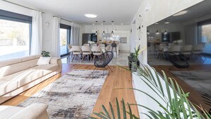 A modern living room with a sofa, dining area, and kitchen. - Luxurious Sanctuary Villa Primorski Dolac With Pool (Primorski Dolac)