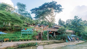 A riverside lodge with wooden structures, a dock, and a sign reading "Dreams of Loboce." - BUSAI DREAM FALLS RESORT (Sevilla)