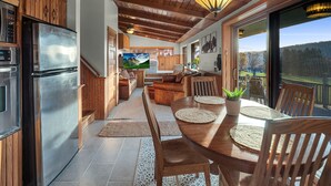 A modern kitchen with stainless steel appliances, wooden cabinetry, and a large island. - The Eagles Nest – Couples Escape - Hot Tub & Views! (Ellicottville)