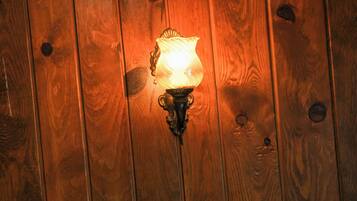 A wooden wall with a wall-mounted light fixture.