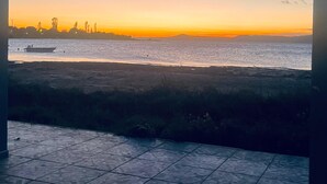 A view of a sunset over a body of water with a boat in the distance. - ASTROİA OTEL & BİLİM KAMPI (Lapseki)