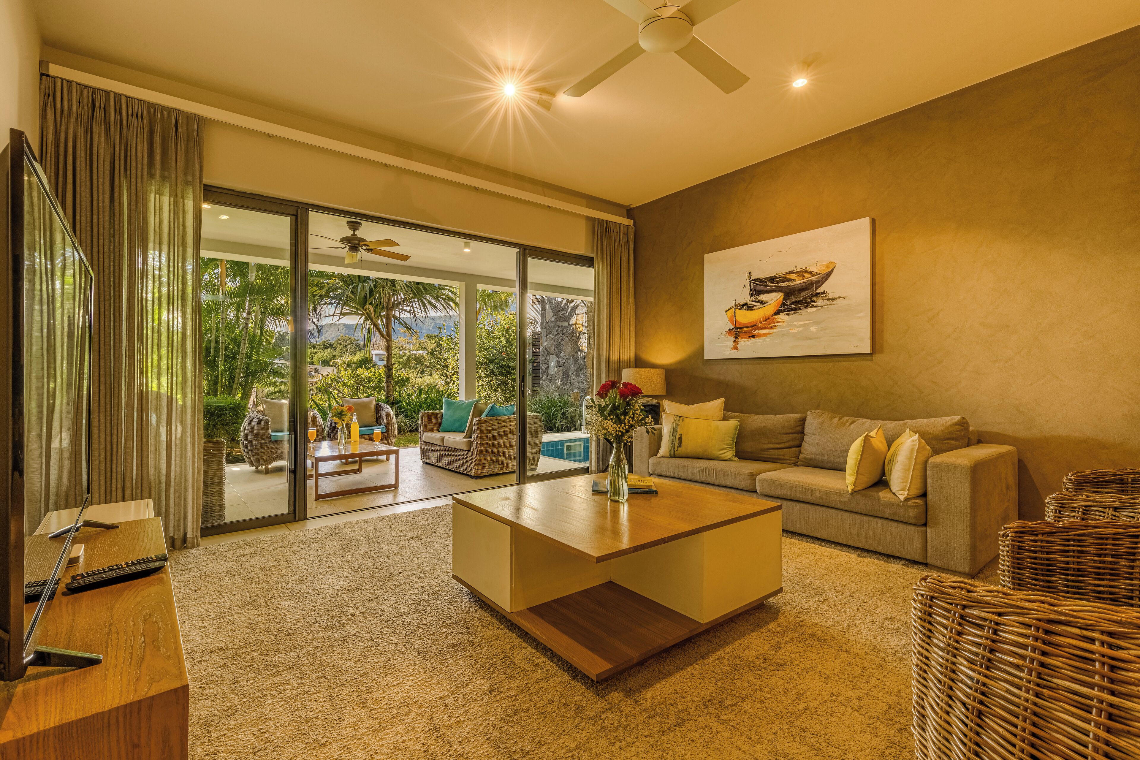 A modern living room with a sofa, coffee table, and a painting on the wall.