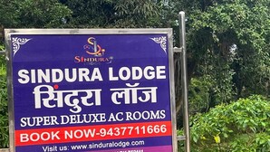 A sign for Sindura Lodge advertising super deluxe AC rooms. - Sindura Lodge (Gop)