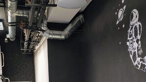 A conference room with a long table, four chairs, and a whiteboard. - Capsule hostel Floor -1 Self Check in (Warsaw)