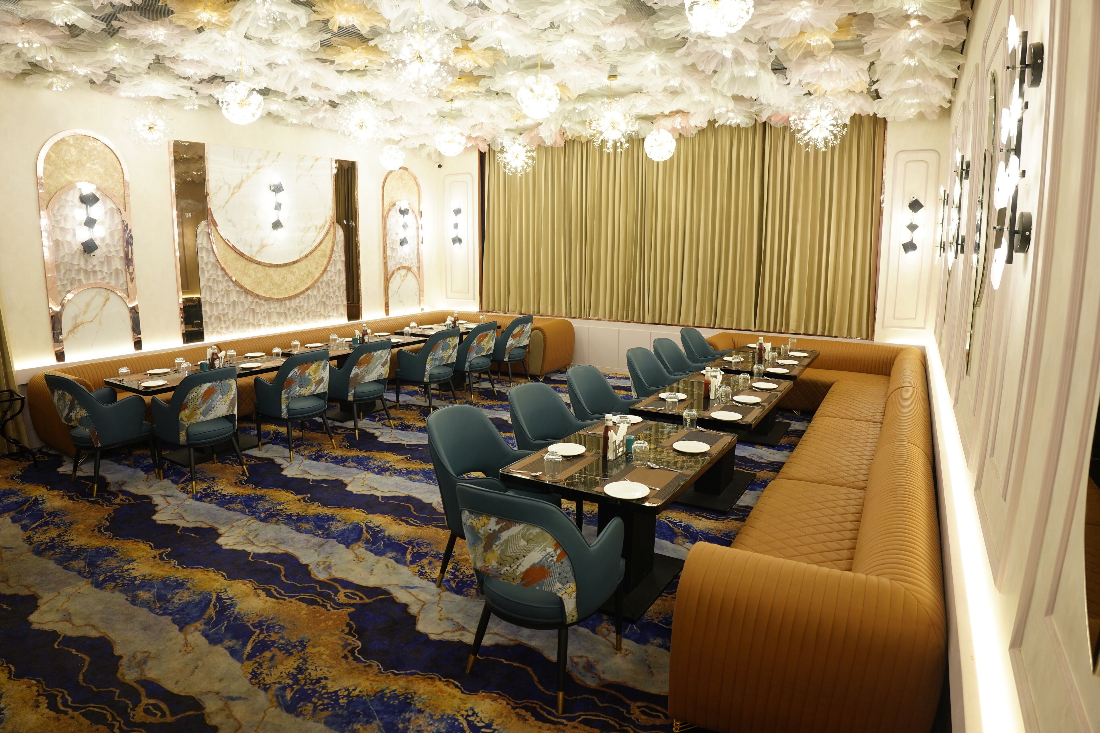 A conference room with a long table, multiple chairs, and a cushioned bench.