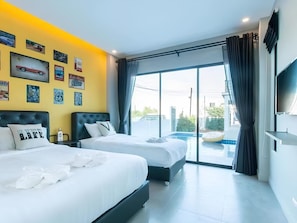 A modern hotel room with two beds, a large window with a view of a swimming pool, and various wall decorations.