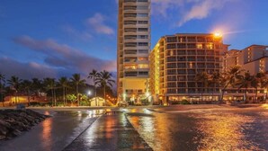 A hotel with a modern design, featuring a prominent tower and a curved building. - 1 Bedroom Suite with Breathtaking Ocean Views! Waikiki Shore 1210 (HONOLULU)