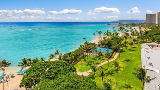 A coastal resort with a beach, palm trees, and a pool area. - 1 Bedroom Suite with Breathtaking Ocean Views! Waikiki Shore 1210 (HONOLULU)