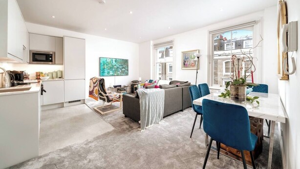 A modern apartment with a kitchen, dining area, and living space.