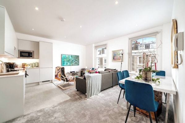 Enjoy a comfortable stay in this apartment with a spacious living area, dining table for four, and fully equipped kitchen.