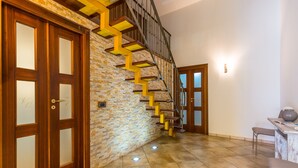 A staircase with wooden steps and a stone wall. - Partenope Spacious Home (Naples)