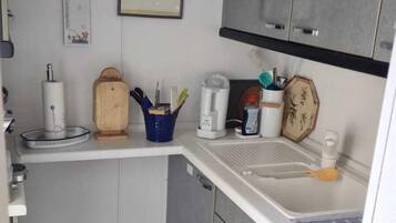 Fridge, coffee/tea maker, cookware/dishes/utensils, dining tables