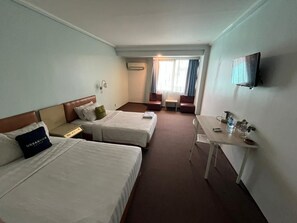 A hotel room with two beds, a desk, a TV, and a window with curtains. - Hotel O Kebayoran (Jakarta)