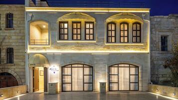 A historic building with arched windows and a well-lit entrance.