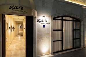 A hotel entrance with a sign reading "Mare Cappadocia" and a wheelchair accessibility symbol. - Mare Cappadocia - Adults Only (Nevsehir)