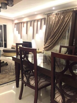 Enjoy meals in this stylish dining area with a glass-top table and comfortable seating.