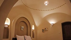 A bedroom with a bed, arched ceiling, and wall-mounted lights. - Malkata House Ground Floor Suite, Pool & Dine & Tours (Luxor)