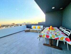 Enjoy al fresco dining on the rooftop with a city view.