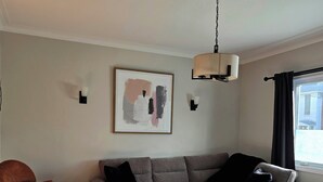 A modern living room with a sectional sofa, a round coffee table, and a patterned rug.