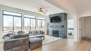 A spacious living room with a large sectional sofa, a fireplace, and a ceiling fan. - 3 Mi to Fairplay Beach: Mountain Getaway (Fairplay)