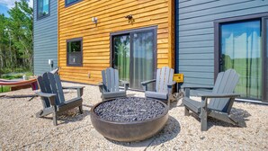 A modern building with a wooden exterior, a fire pit, and two Adirondack chairs. - 3 Mi to Fairplay Beach: Mountain Getaway (Fairplay)