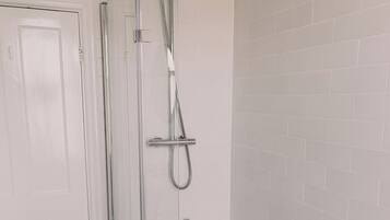 Shower, hair dryer, towels, toilet paper