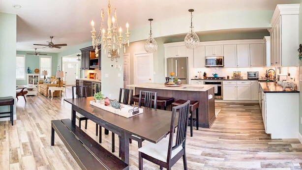 A spacious kitchen with a central island, modern appliances, and elegant lighting fixtures. - Lilys Pad Home with Gourmet Kitchen, Near Beach (Cape Charles)