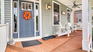 A house with a blue front door, a wreath, and a porch with white chairs. - Lilys Pad Home with Gourmet Kitchen, Near Beach (Cape Charles)