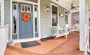 A house with a blue front door, a wreath, and a porch with white chairs. - Lilys Pad Home with Gourmet Kitchen, Near Beach (Cape Charles)
