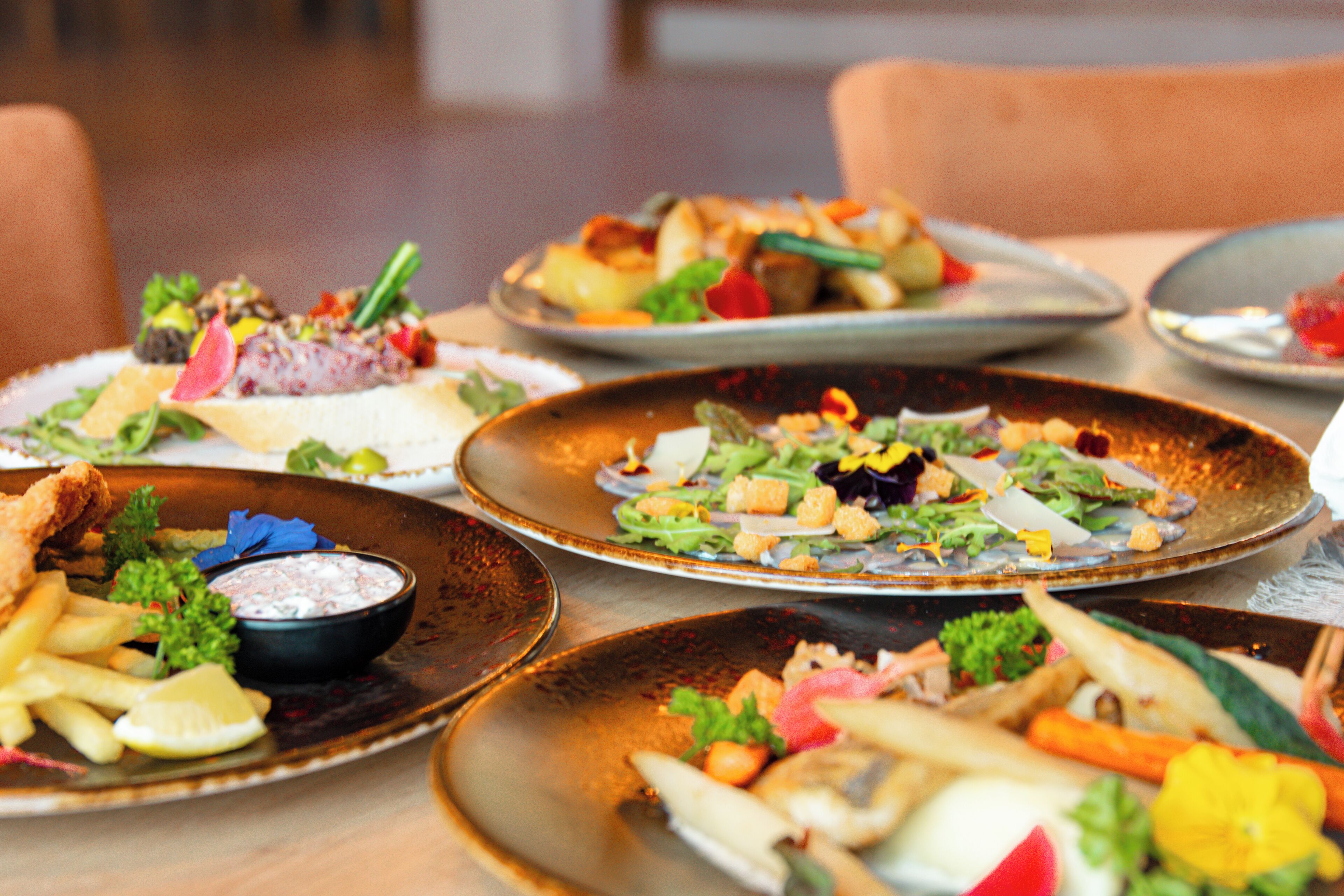 A table with various dishes including seafood, salads, and sides.