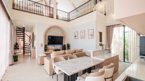A spacious living area with a marble dining table, a sofa set, and a TV. - Oxygen Valley Khao Yai C8 (Pak Chong)
