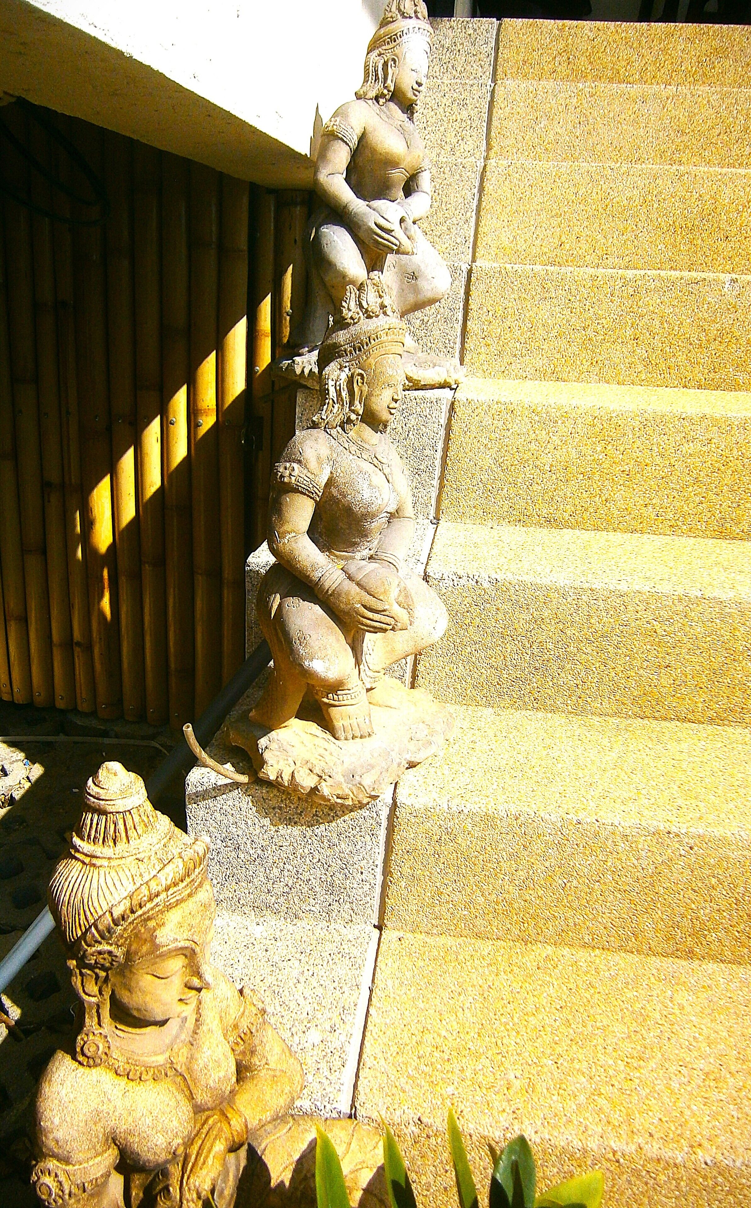 A stone staircase with a series of statues.