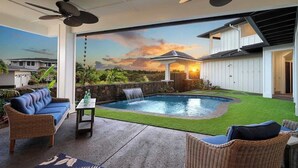A backyard with a swimming pool, a gazebo, and outdoor furniture.