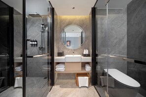 A modern bathroom with a glass-enclosed shower, a round mirror, a white sink, and a freestanding bathtub. - JunYa Hotel of Hibiscus town (Xiangxi)