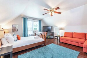 A bedroom with a bed, a TV, a sofa, and a ceiling fan. - Charming 3bed Home w/ Yard - Walk Score 91! (Portland)